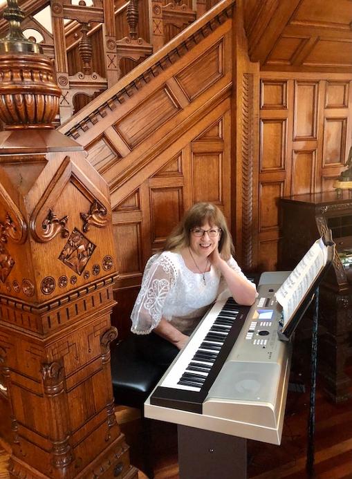Rebecca playing piano at Queen Anne